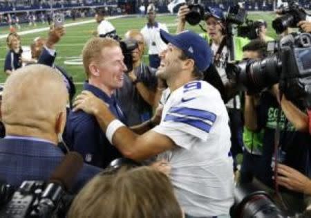 Sep 13, 2015; Arlington, TX, USA; Dallas Cowboys quarterback Tony Romo (9) celebrates a victory with head coach Jason Garrett after the game against the New York Giants at AT&T Stadium. Mandatory Credit: Matthew Emmons-USA TODAY Sports