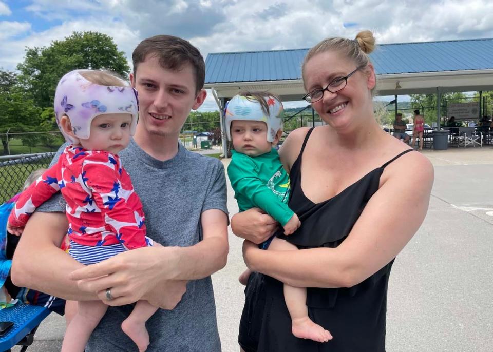 Twins Tillie and Connor Geiger, 8 months, are secure in their helmets at their first visit to the pool with their parents, Chris and Carin Geiger, at the Lions Club Karns Community Pool opening day Saturday, May 28, 2022.