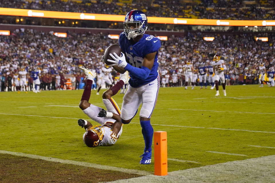 FILE - New York Giants wide receiver Darius Slayton (86) makes a touchdown catch against Washington Football Team cornerback William Jackson (23) during the second half of an NFL football game in Landover, Md., in this Thursday, Sept. 16, 2021, file photo. The Kansas City Chiefs and Washington head into their matchup this weekend as two of the worst defenses in the NFL. No teams have allowed more points this season and they're both coming off allowing 30-plus points last week. (AP Photo/Alex Brandon, File)