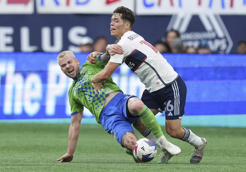 Seattle Sounders' Albert Rusnak, left, and Vancouver Whitecaps' Sebastian Berhalter vie for the ball during the first half of an MLS soccer match in Vancouver, British Columbia on Saturday, May 20, 2023. (Darryl Dyck/The Canadian Press via AP)