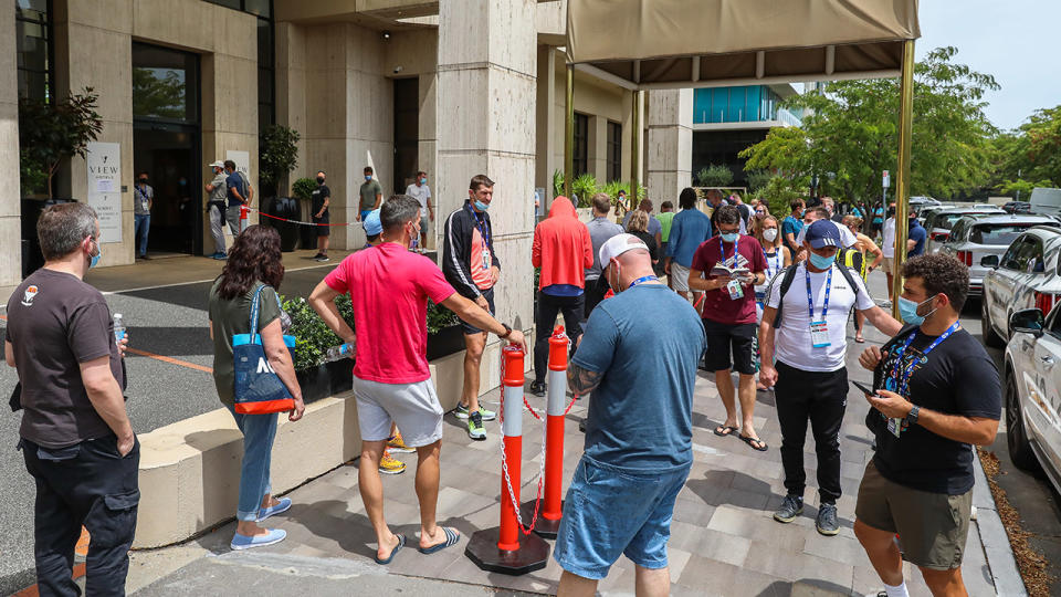 People associated with the Australian Open, pictured here lining up at a testing facility at the View Melbourne Hotel.