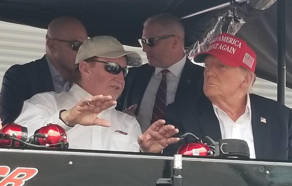 Former President Donald Trump sits in the pit box of driver Austin Dillion with Richard Childress, owner of Richard Childress Racing.