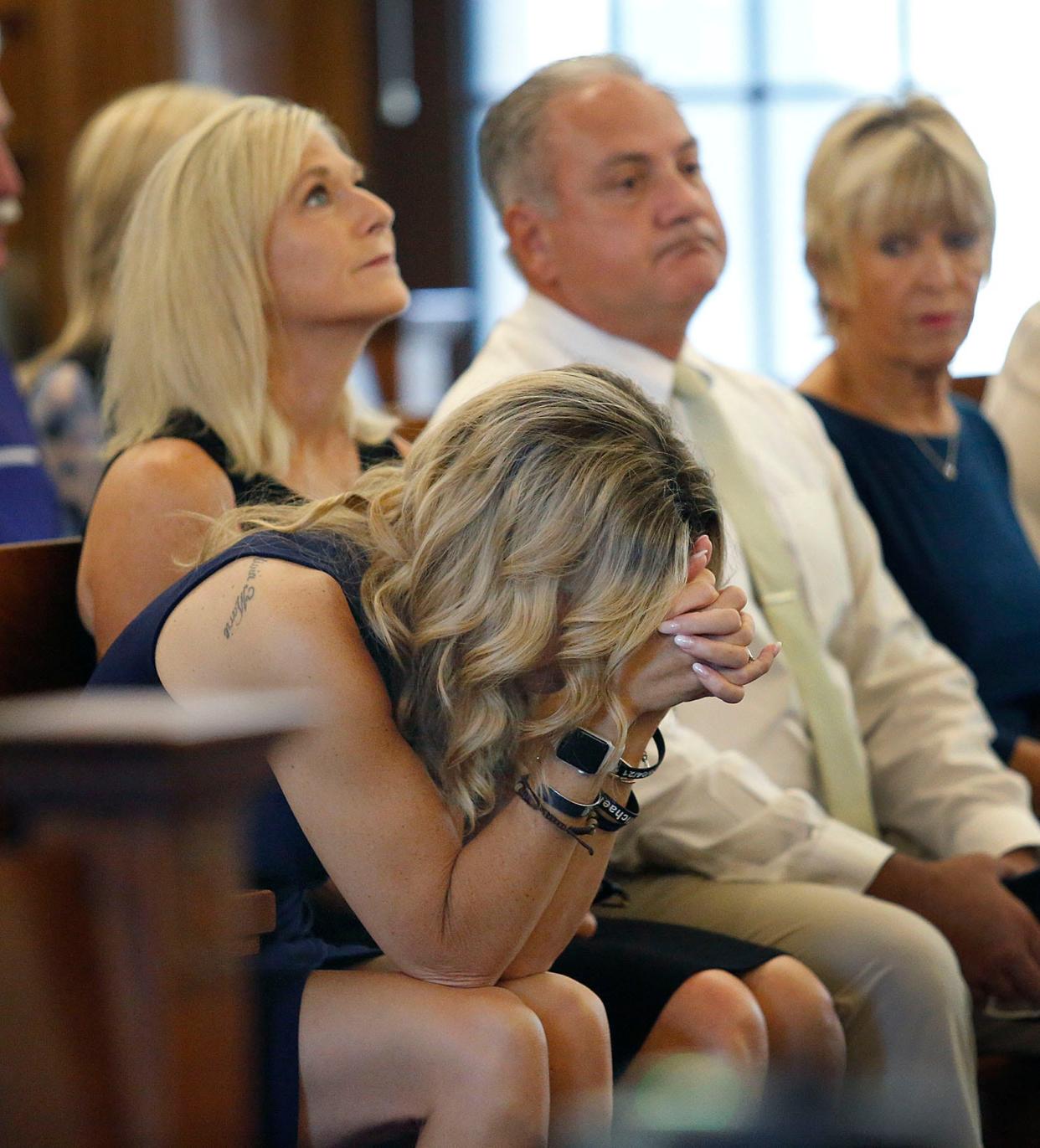 Cindy Chesna, left, and her family react to the restart of jury deliberations Wednesday in the trial of the man accused of murdering her husband, Weymouth police Sgt. Michael Chesna, and town resident Vera Adams.