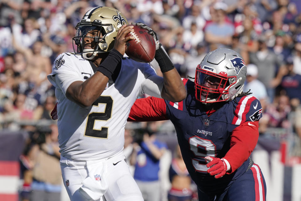 New Orleans Saints quarterback Jameis Winston (2) eludes New England Patriots outside linebacker Matt Judon (9) as he looks to pass during the second half of an NFL football game, Sunday, Sept. 26, 2021, in Foxborough, Mass. (AP Photo/Steven Senne)