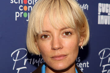 Lily Allen poses for a photo with her head titled