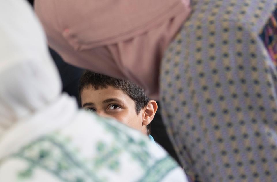 Saleh Humaid, 8, of Gaza, talks with women during a community meet and greet with Saleh at the Hanini Outreach and Community Center in Dearborn on Sunday, June 25, 2023, put on by the Palestine Children's Relief Fund's Detroit chapter. Saleh's leg was bombarded with the shrapnel from an exploding car he and his dad happened to be passing in the road as it was targeted for a drone strike. The damage to his nerves was too severe to repair and surgeons in the Gaza Strip could not save his limb.