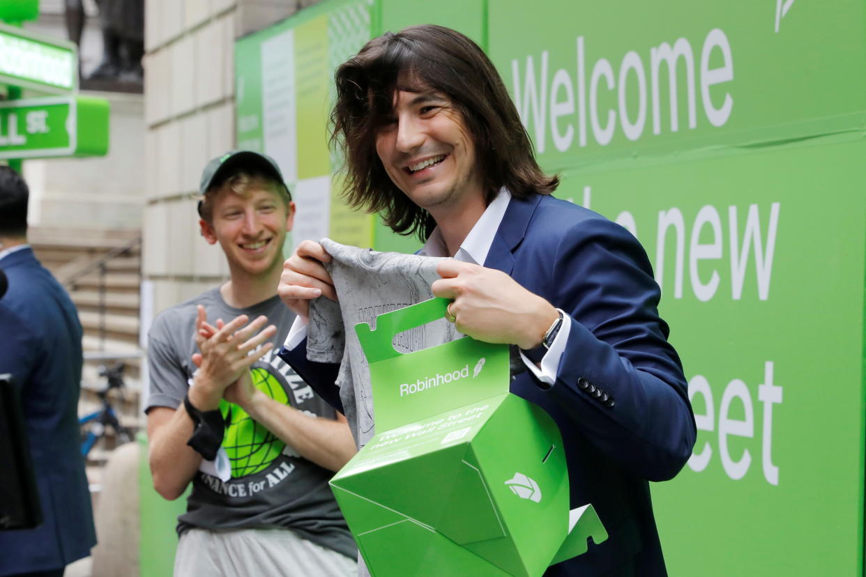 Robinhood Markets, Inc. CEO and co-founder Vlad Tenev holds a t-shirt on Wall Street after the company's IPO in New York City, U.S., July 29, 2021.  REUTERS/Andrew Kelly