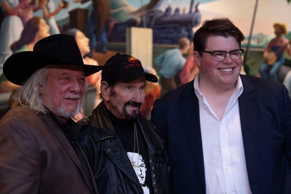 John Anderson, James Burton and Stelen Keith Covel, standing for his father, Toby Keith, after being announced a 2024 inductees into the Country Music Hall of Fame in the rotunda at the Country Music Hall of Fame and Museum in Nashville, Tenn., Monday, March 18, 2024.