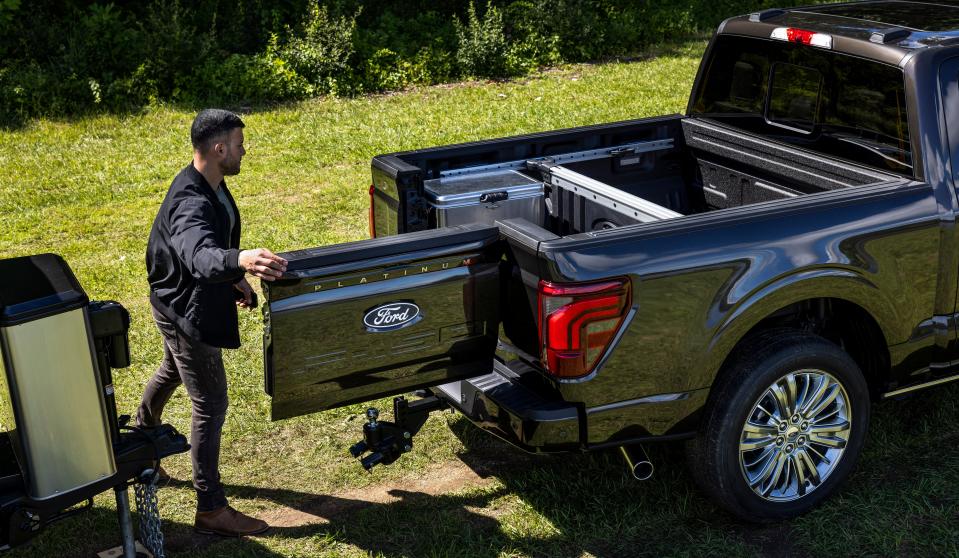 A man uses the new Ford F-150's Pro Access Tailgate