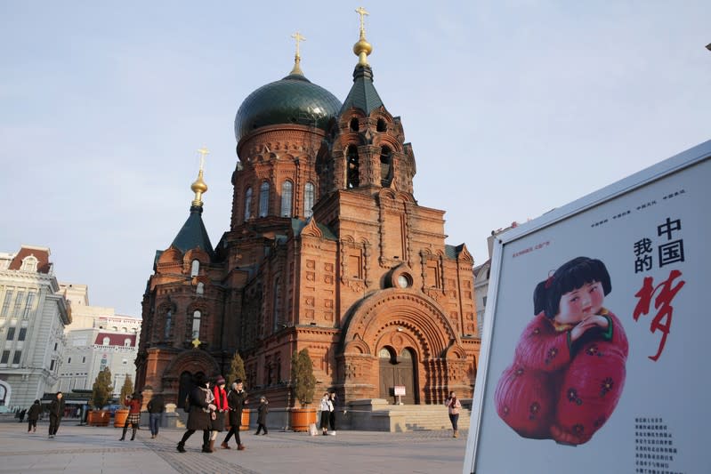 A poster promoting "China Dream" is placed next to the Saint Sophia Cathedral in Harbin