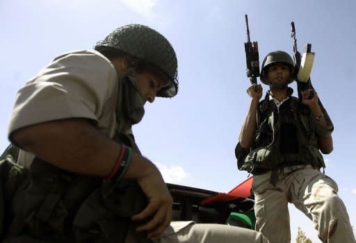 Libyan National Transitional Council (NTC) fighters gather at an outpost on the outskirts of the city of Bani Walid. Libya's new rulers on Wednesday declared victory in the battle for the key southern city of Sabha, one of the last bastions of deposed despot Moamer Kadhafi's diehard supporters