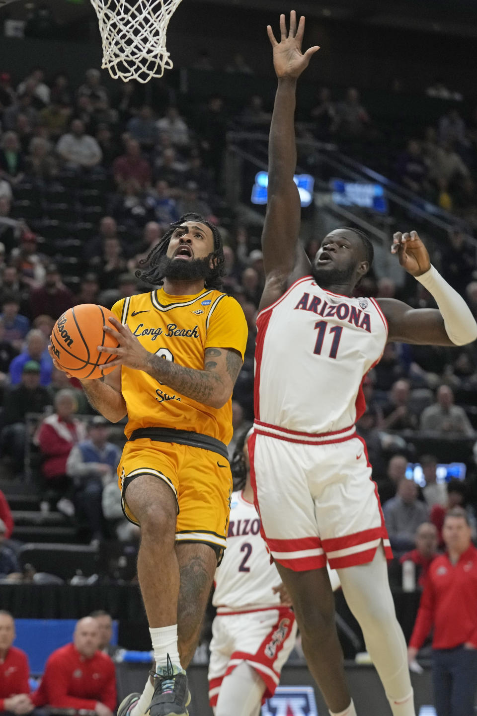 Long Beach State guard Marcus Tsohonis (0) goes to the basket as Arizona center Oumar Ballo (11) defends during the first half of a first-round college basketball game in the NCAA Tournament in Salt Lake City, Thursday, March 21, 2024. (AP Photo/Rick Bowmer)
