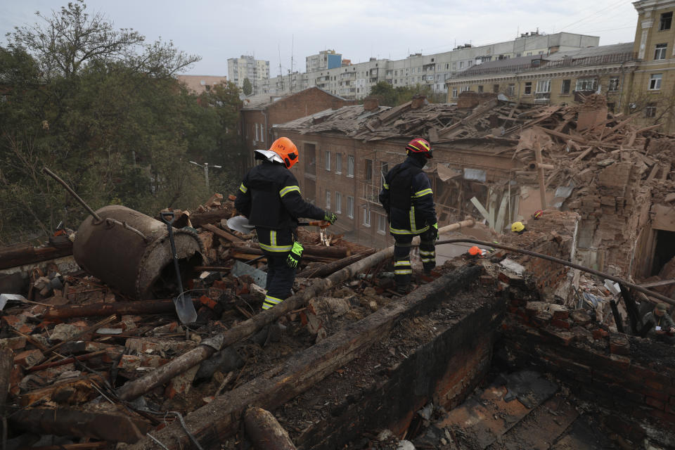 Emergency workers search for victims after a Russian air attack that damaged an apartment building in central Kharkiv, Friday, Oct. 6, 2023. (AP Photo/Alex Babenko)