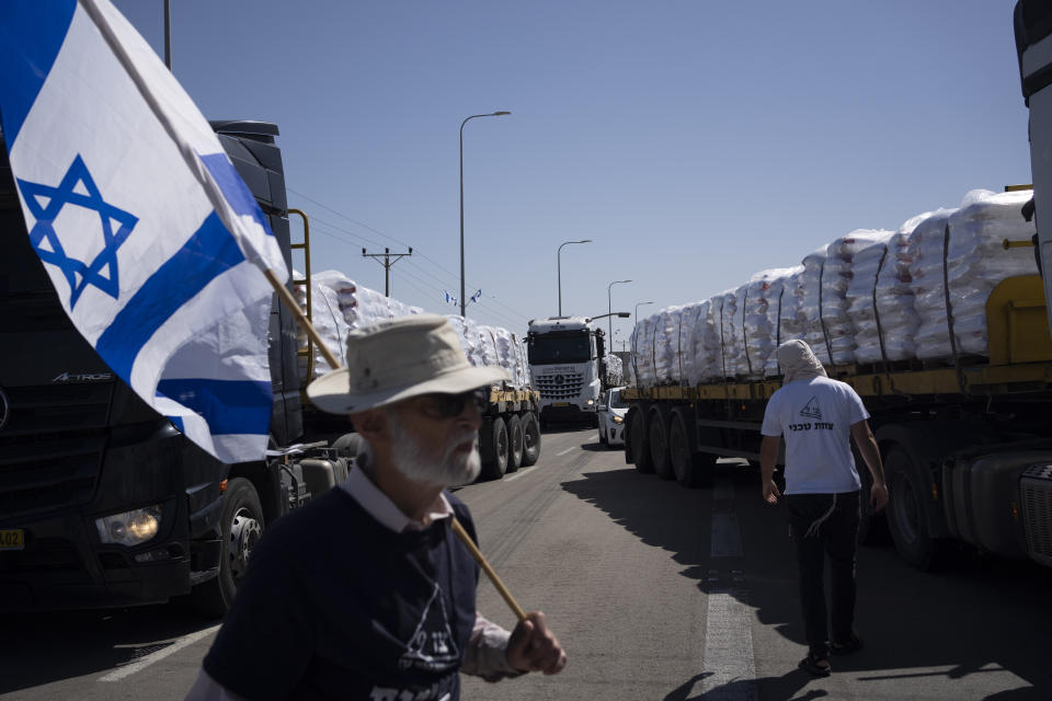 People block a road as they try to stop the trucks, carrying humanitarian aid, to enter in the Gaza Strip in an area near the Kerem Shalom border crossing between Israel and Gaza, in southern Israel, in Kerem Shalom, Thursday, May 9, 2024. (AP Photo/Leo Correa)