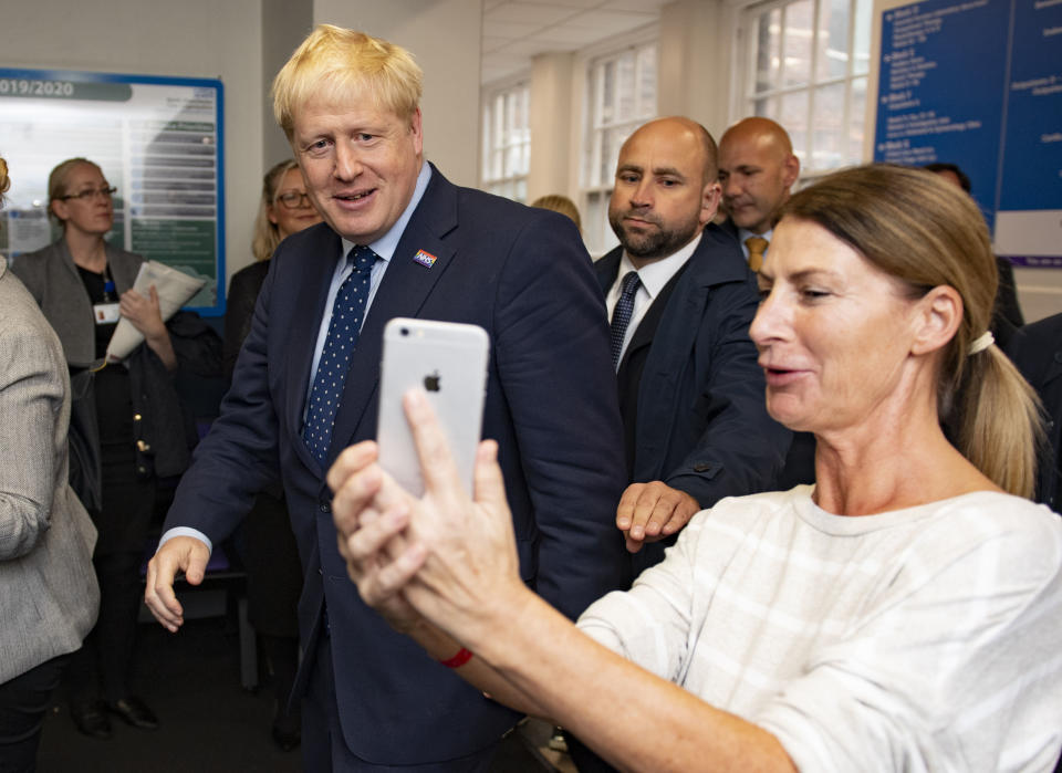 Britain's Prime Minister Boris Johnson looks on during a visit to North Manchester General Hospital before the Conservative Conference, in Manchester, England, Sunday, Sept. 29, 2019. British Prime Minister Boris Johnson has urged calm as tempers flare in the debate over Britain's departure from the European Union, even though tempers are flaring over what he said. A defiant Johnson told the BBC on Sunday that the "best thing for the country and for people's overall psychological health would be to get Brexit done." (Andy Stenning/Pool Photo via AP)