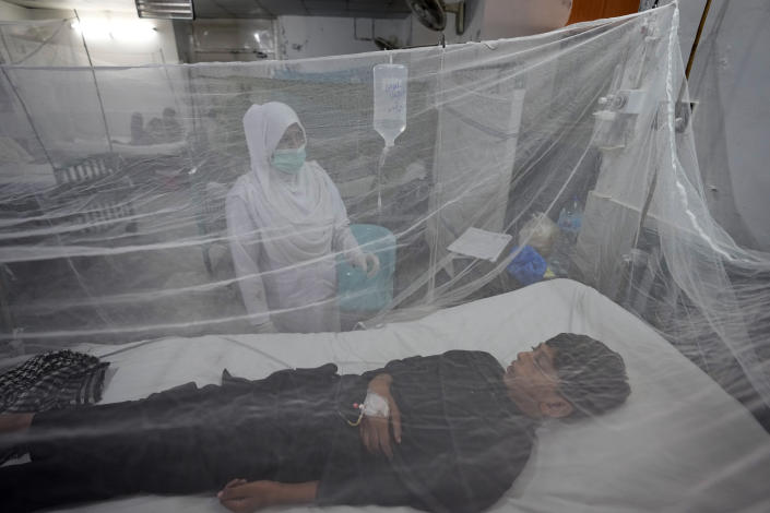 Pakistani patients suffering from dengue fever, a mosquito-borne disease, are treated in an isolation ward, at a hospital in Lahore, Pakistan, Friday, Sept. 23, 2022. Pakistan has deployed thousands of additional doctors and paramedics in the country's worst flood-hit province to contain the spread of diseases that have killed over 300 people among the flood victims, officials said Friday. (AP Photo/K.M. Chaudary)