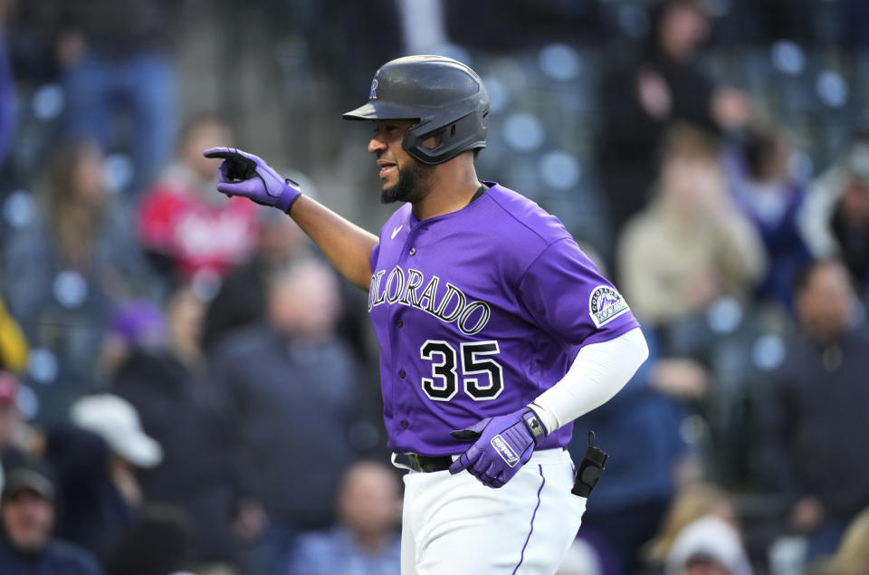 Colorado Rockies' Elias Diaz celebrates as he crosses home plate after hitting a solo home run off Cincinnati Reds starting pitcher Hunter Greene during the second inning of a baseball game Friday, April 29, 2022, in Denver. (AP Photo/David Zalubowski)