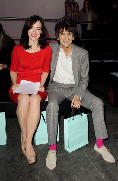 <b>Ronnie Wood and Sally Humphreys</b><br><br>The former Rolling Stones star donned a tweed grey suit, hot pink suits and greige shoes while his wife wore a red dress and nude heels for the Topman fashion show in London.