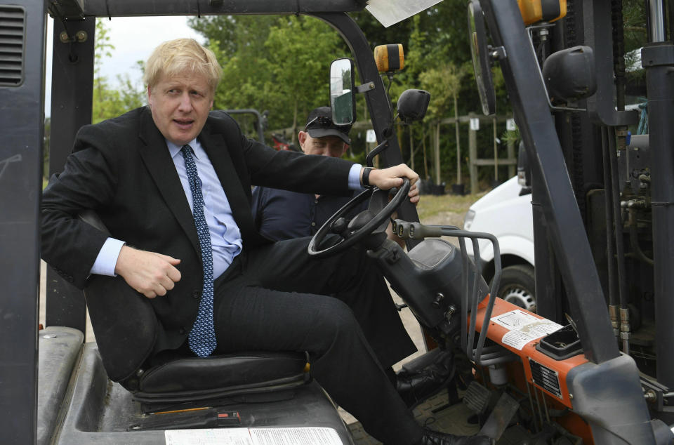 Conservative Party leadership candidate Boris Johnson in a fork lift truck during a visit to King & Co tree nursery, in Braintree, Essex, ahead of a Tory leadership hustings, England, Saturday, July 13, 2019. (Neil Hall/Pool photo via AP)