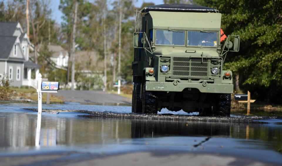 A truck with Pender County Fire drives into a flooded neighborhood in Hampstead days after Hurricane Florence swamped the Cape Fear region with record-setting rains.