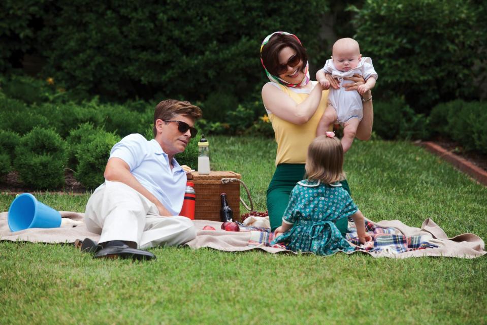 This image released by the National Geographic Channel shows Rob Lowe, left, as President John F. Kennedy and Ginnifer Goodwin, right, as Jackie Kennedy having a family picnic on the White House Lawn during the filming of "Killing Kennedy." A wide range of actors have played President John F. Kennedy in the movies and on TV. (AP Photo/National Geographic Channel, Kent Eanes)??