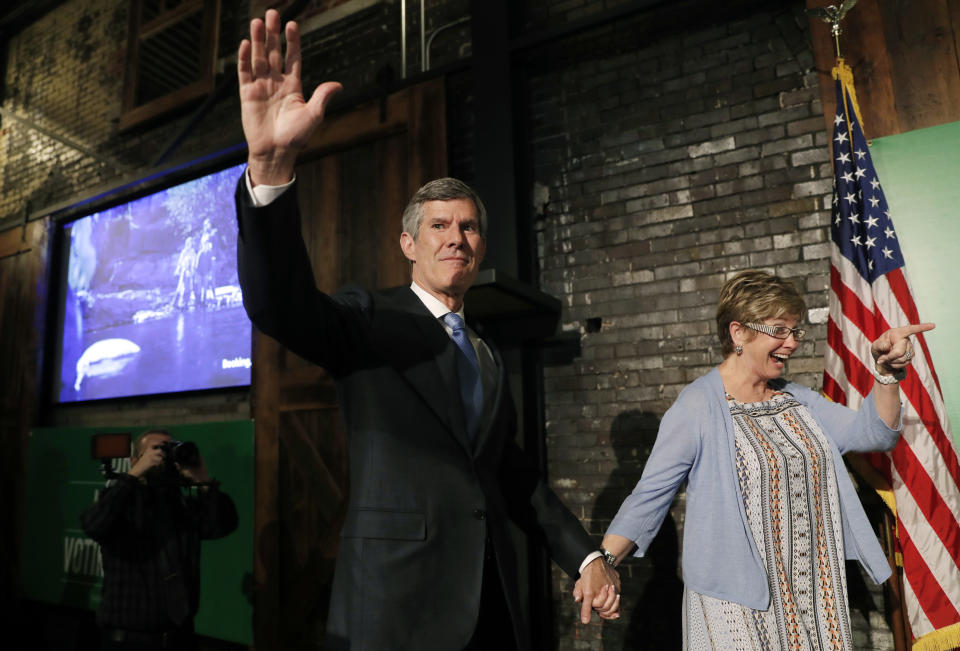 Fred Hubbell waves while holding hands with his wife, Charlotte, during a rally in Des Moines, Iowa, June 5, 2018. (Photo: Charlie Neibergall/AP)