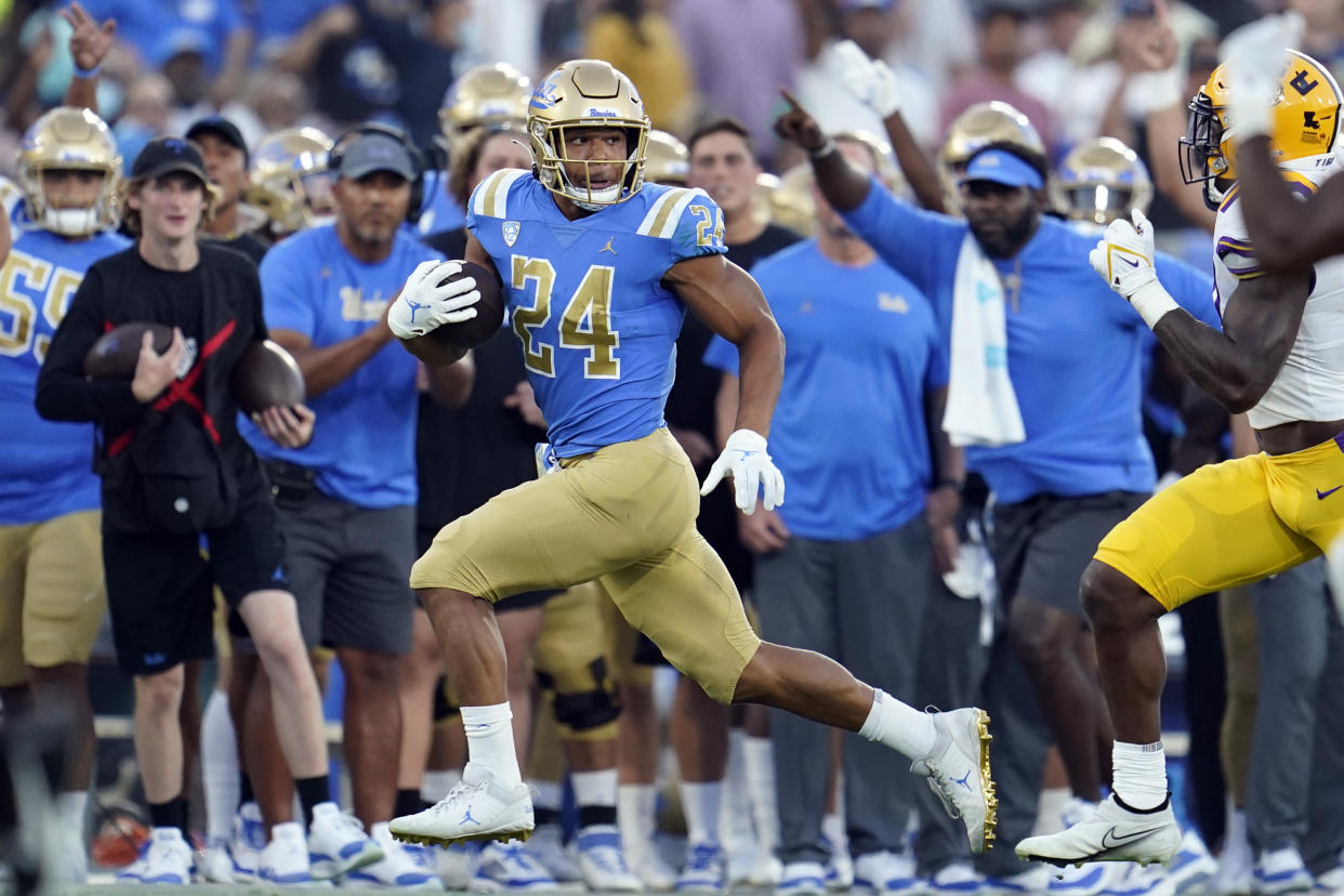 UCLA running back Zach Charbonnet (24) looks back at an LSU defender during the first half of an NCAA college football game Saturday, Sept. 4, 2021, in Pasadena, Calif. (AP Photo/Marcio Jose Sanchez)