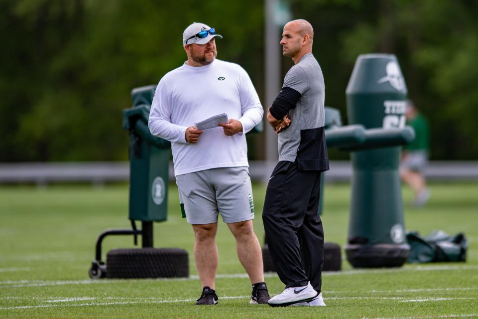 May 27, 2021; Florham Park, NJ, USA; New York Jets general manager Joe Douglas (left) chats with head coach Robert Saleh during an OTA at Jets Atlantic Health Training Center. Mandatory Credit: John Jones-USA TODAY Sports