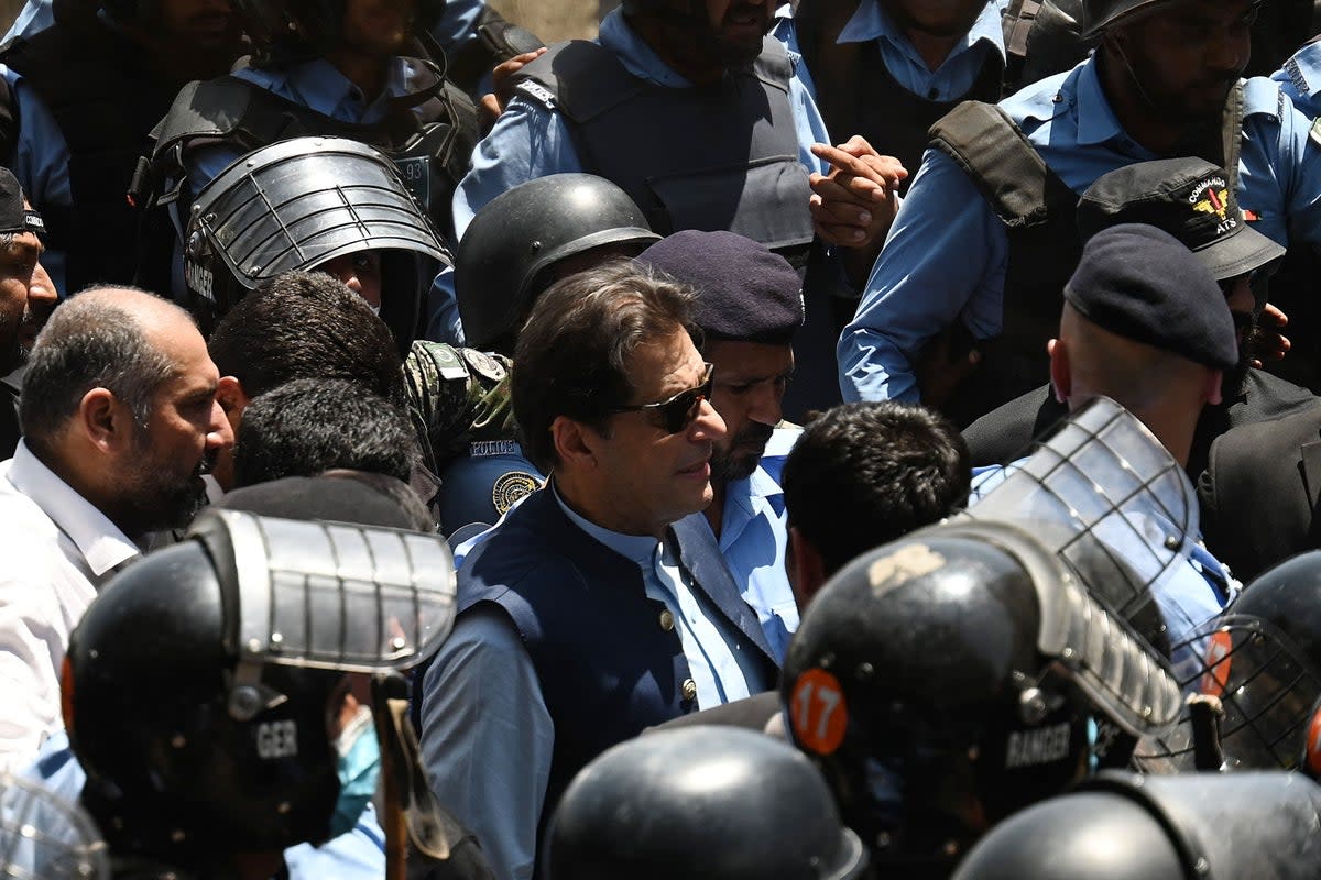 File. Police cammandos escort former Pakistan’s prime minister Imran Khan (C) as he arrives at the high court in Islamabad (AFP via Getty Images)