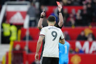 Fulham's Aleksandar Mitrovic is shown red card during the English FA Cup quarterfinal soccer match between Manchester United and Fulham at the Old Trafford stadium in Manchester, England, Sunday, March 19, 2023. (AP Photo/Jon Super)