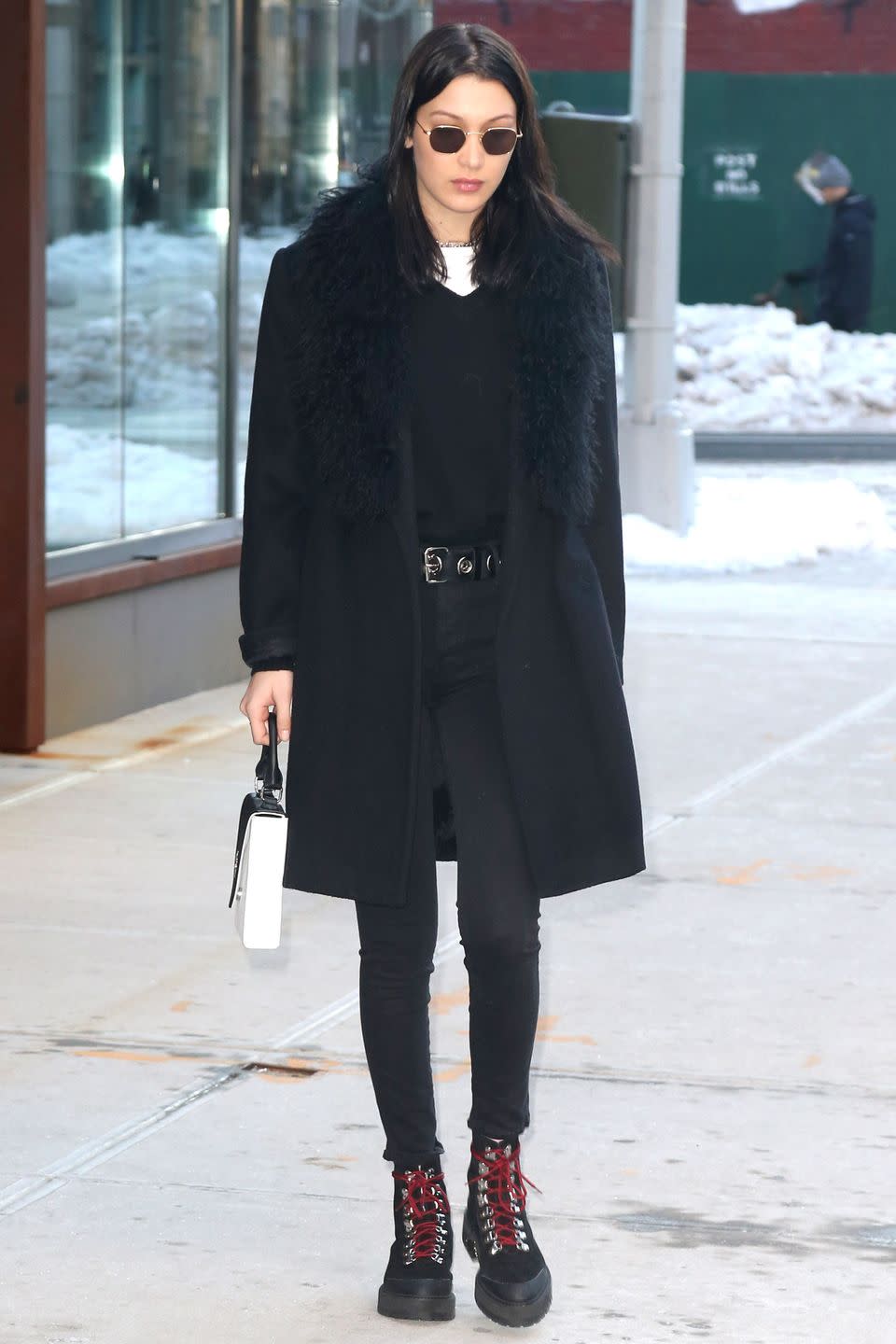 <p>In a black fur coat, skinny jeans, lace-up boots, v-neck sweater, white tee and Krewe rounded sunglasses while out in New York.</p>