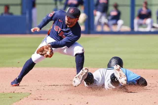 Miami Marlins' Peyton Burdick, bottom, steals second base under