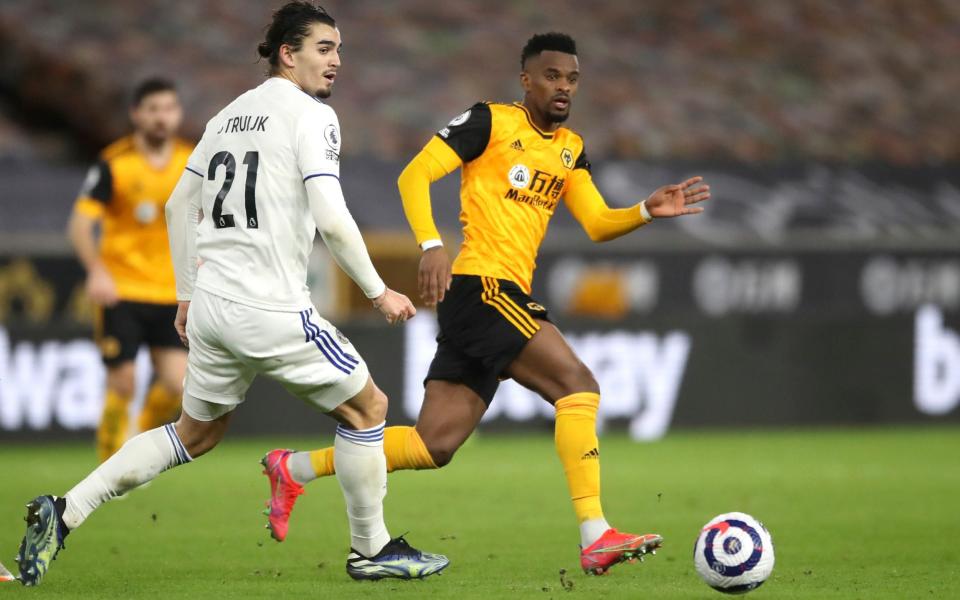 Leeds United's Pascal Struijk, left, and Wolverhampton Wanderers' Nelson Semedo challenge for the ball during the English Premier League  - AP