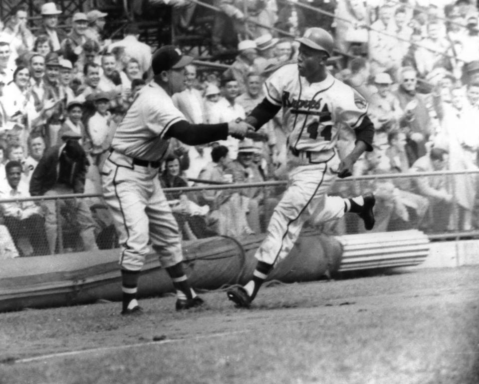 An undated Press Photo shows a young Henry "Hank" Aaron in rounding bases as a Milwaukee Brave.