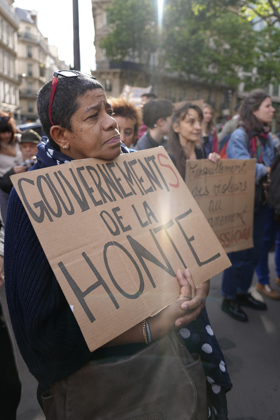 A woman shows a poster reading "Government of shame" during a demonstration organized by a feminist association called the Observatory on Sexual and Gender-based violence in politics, Tuesday, May 24, 2022 in Paris. Rape accusations against a newly named French government minister have galvanized a movement aimed at exposing sexual misconduct in French politics and encouraging women to speak out against abusers. (AP Photo/Nicolas Garriga)