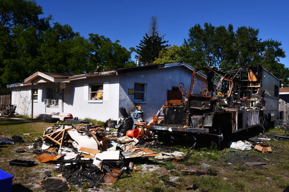 Melbourne code enforcement officials have condemned the derelict home at the intersection of Sherwood Boulevard and Warwick Road, prohibiting occupancy. The burnt wreckage of a recreational vehicle is parked to the right of the house.