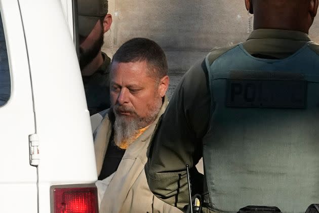 Officers escort Richard Allen out of a courthouse following a hearing on Nov. 22, 2022, in Delphi, Indiana.