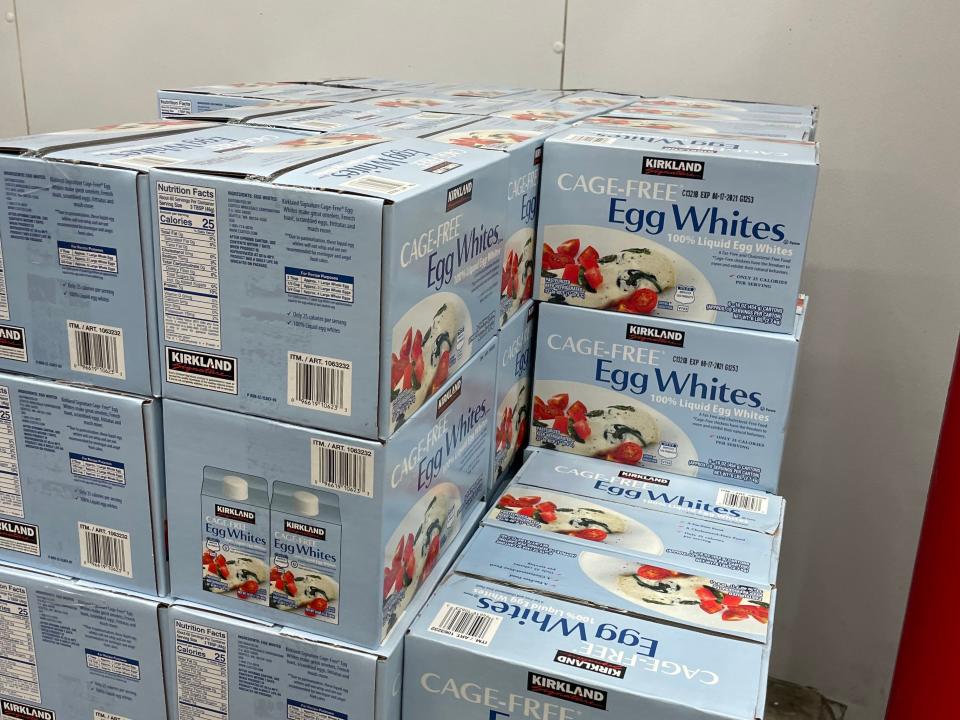 stacked blue boxes of egg whites at costco