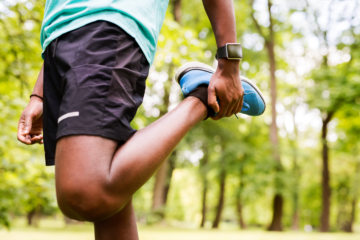 Man stretching his leg before a run