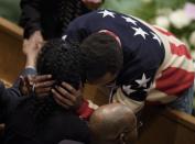 Gloria Darden is embraced while waiting before her son Freddie Gray's funeral at New Shiloh Baptist Church April 27, 2015 in Baltimore, Maryland