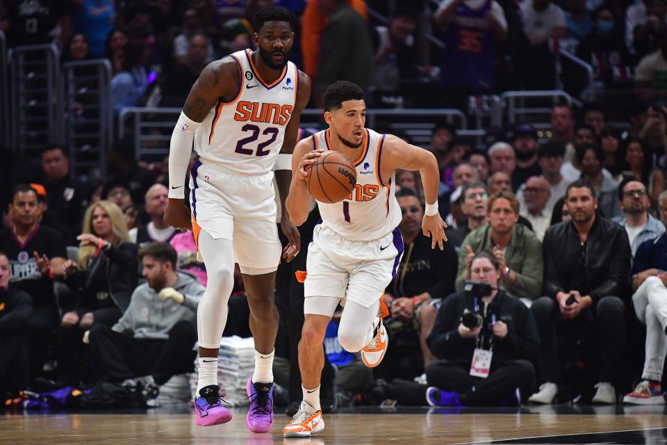 Phoenix Suns guard Devin Booker (1) moves the ball as center Deandre Ayton (22) trails against the Los Angeles Clippers during the first half in game four of the 2023 NBA playoffs at Crypto.com Arena on April 22, 2023.