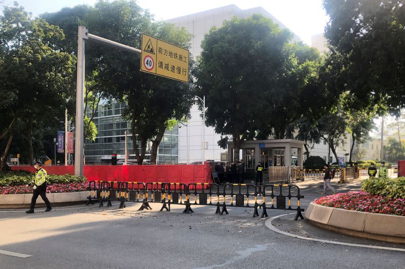 Police officers are seen outside a court in Shenzhen