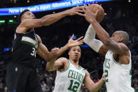 Milwaukee Bucks forward Giannis Antetokounmpo (34) and Boston Celtics center Al Horford, right, battle for the ball during the first half of Game 5 of an Eastern Conference semifinal in the NBA basketball playoffs, Wednesday, May 11, 2022, in Boston. (AP Photo/Charles Krupa)