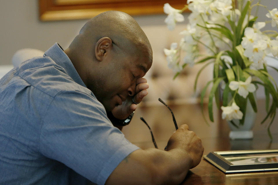 In this Friday, June 14, 2019 photo, Chris Parks wipes away a tear while talking about the murder of his brother Donovan Corey Parks in Powder Springs, Ga.. Marion Wilson Jr. and Robert Earl Butts Jr. were convicted of murder and sentenced to death in the March 1996 killing of 24-year-old Donovan Corey Parks. Butts was executed in May 2018. Wilson, who’s 42, is set for execution Thursday, June 20. (AP Photo/Andrea Smith)
