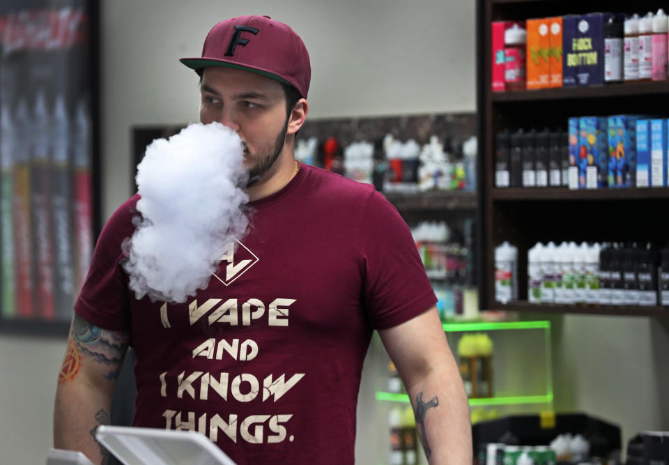 NASHUA, MA - NOVEMBER 26: Ken Irons, the general manager at Arcus Vapors, blows smoke in his Nashua, NH store on Nov. 26, 2019. Along the border in New Hampshire and Maine, sales of nicotine and cannabis vaping products boomed after Sept. 24, when Massachusetts Governor Charlie Baker banned both amid an outbreak of vaping-related lung injuries. At Arcus Vapors, sales of e-cigarette liquids and equipment have doubled. The ban was lifted on Dec. 11. (Photo by Jim Davis/The Boston Globe via Getty Images)