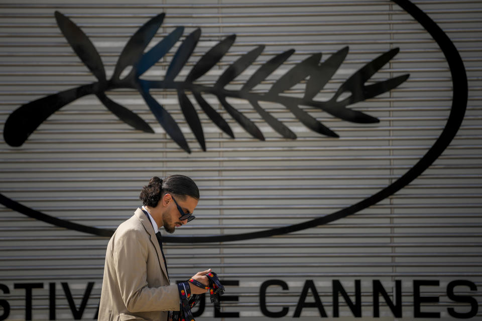 A person walks past the Cannes film festival logo during preparations for the 77th international film festival, Cannes, southern France, Monday, May 13, 2024. The Cannes film festival runs from May 14 until May 25, 2024. (AP Photo/Andreea Alexandru)