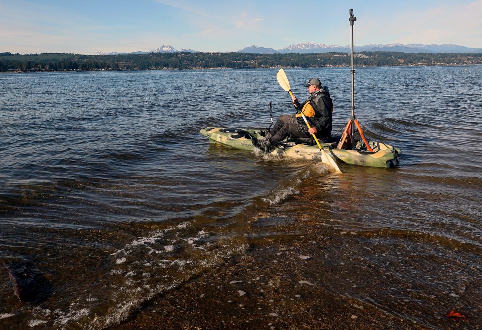 Brian Footen, co-founder and president of EarthViews, hops into his kayak at the Tracyton Boat Launch on Wednesday. Footen and his Seattle startup surveys shorelines of Puget Sound using GoPro cameras and kayaks to create 360-degree views of locations.