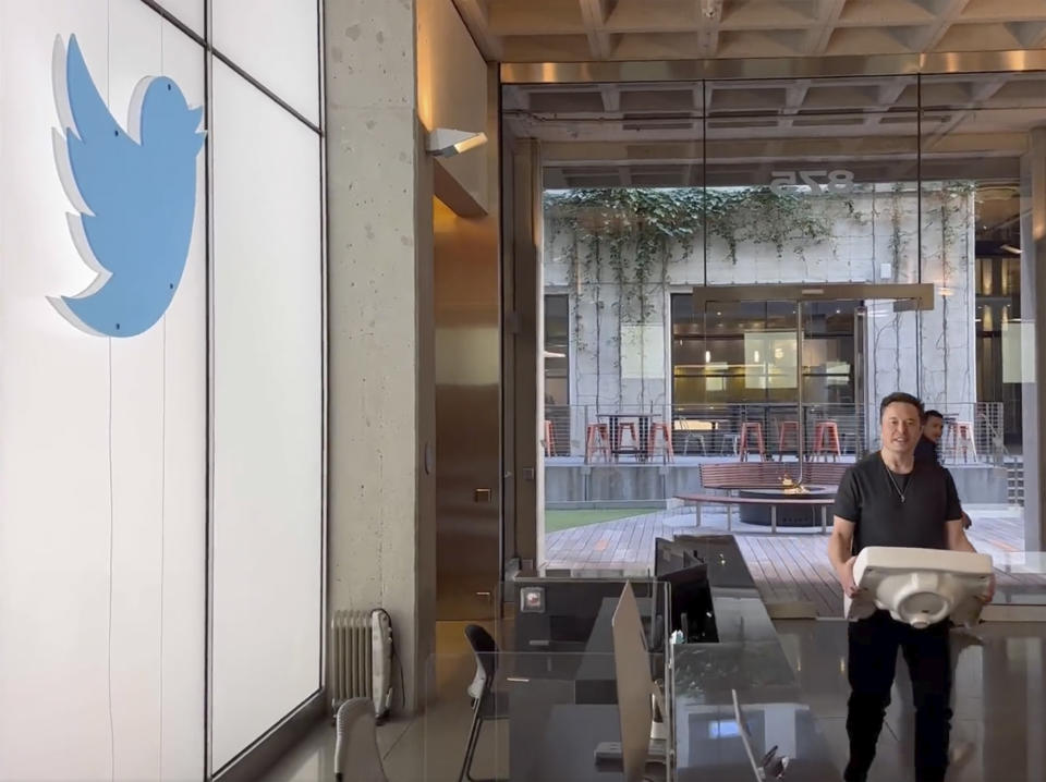 This image from the Twitter page of Elon Musk shows Musk entering Twitter headquarters carrying a sink through the lobby area on Wednesday, Oct. 26, 2022 in San Francisco. Musk posted a video Wednesday showing him strolling into Twitter headquarters ahead of a Friday deadline to close his $44 billion deal to buy the company. (Twitter page of Elon Musk via AP)