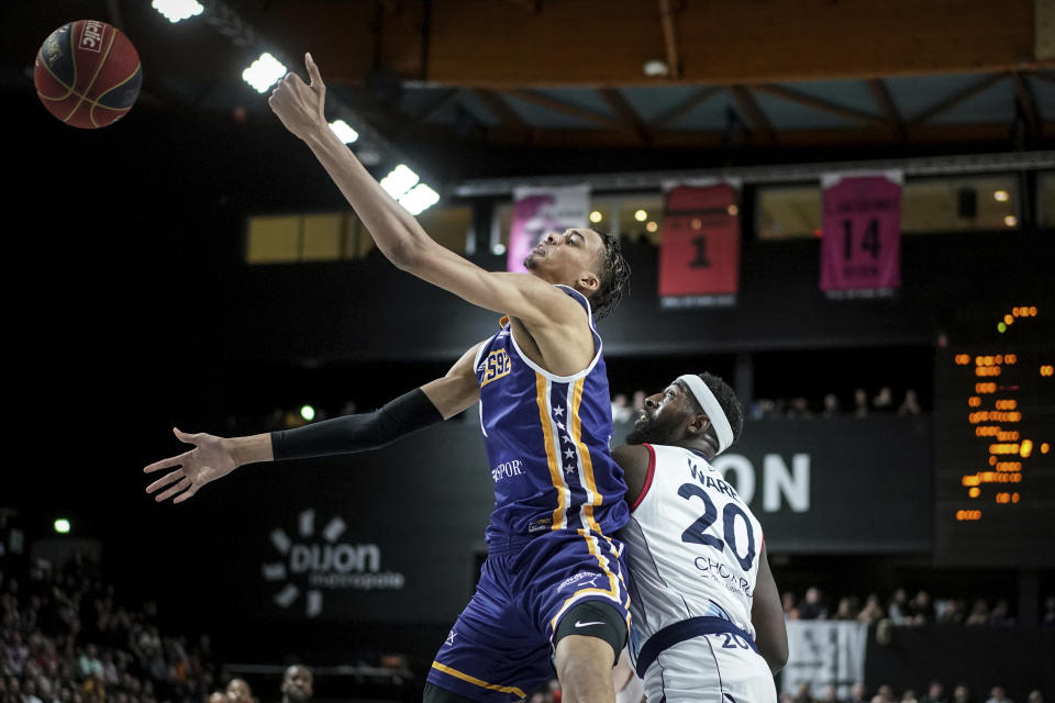 Boulogne-Levallois' Victor Wembanyama jumps to catch the ball during the Elite basketball match Boulogne-Levallois against JDA Dijon at the Palais de Sports Jean-Michel Geoffroy in Dijon, central France, Sunday, Jan. 15, 2023. On Sunday, May 7, 2023, he played before a crowd of about 15,000 fans in Paris as part of his farewell tour before coming to the NBA. Wembanyama is about a week away from learning which team will be picking him in the NBA Draft. (AP Photo/Laurent Cipriani)