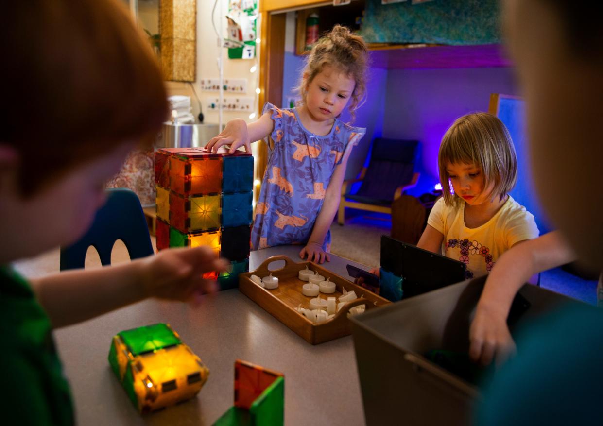 Five-year-olds Lana Wood, center left, and Eleanor Giddens join with classmates at the Lane Child and Family Center in Eugene during playtime Tuesday.